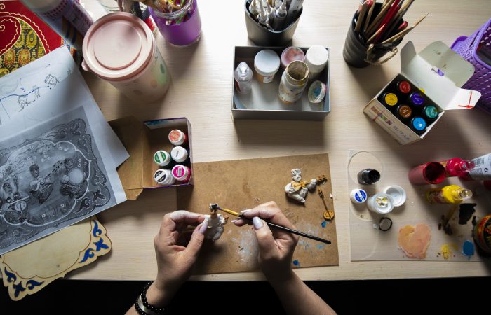 Master painting mini figures with brush. High quality photo